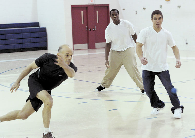 MAKING STRIDES: Ron Cramer, a retired cop and handball enthusiast, works with kids playing handball Dec. 30 at Long Creek Youth Development Center in South Portland. Cramer is seen here with Alex Julien and EJ Rosario.