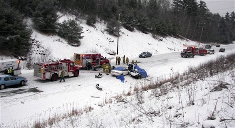 In this Dec. 25 photo, emergency personnel respond to a two-vehicle crash in Palermo, Maine, where four men died in the accident. Officials said the number of highway deaths dipped to the lowest level in more than six decades in Maine and to an all-time low in neighboring New Hampshire in 2011. (AP Photo/Maine State Police, File)