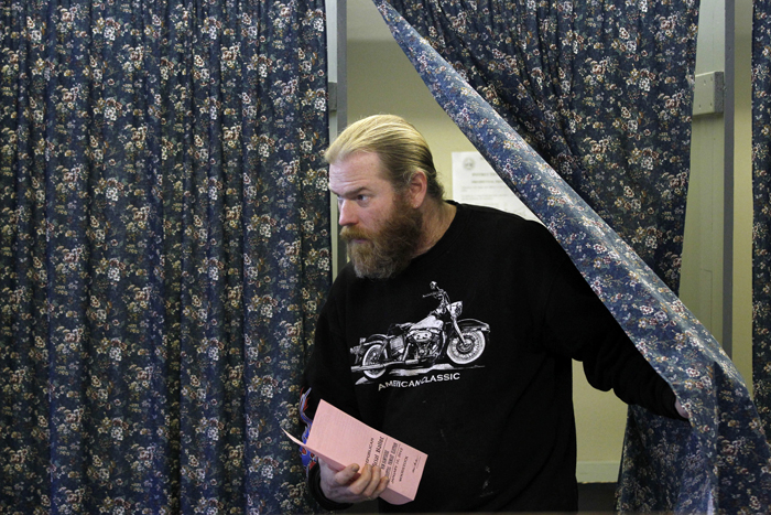 Terry Whipple steps out of a voting booth at the Woodstock Town Hall in Woodstock, N.H., today after casting his vote in the first-in-the-nation presidential primary.