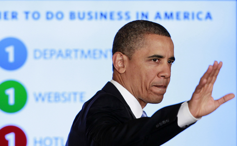 President Barack Obama waves after delivering remarks on government reform today in the East Room of the White House.