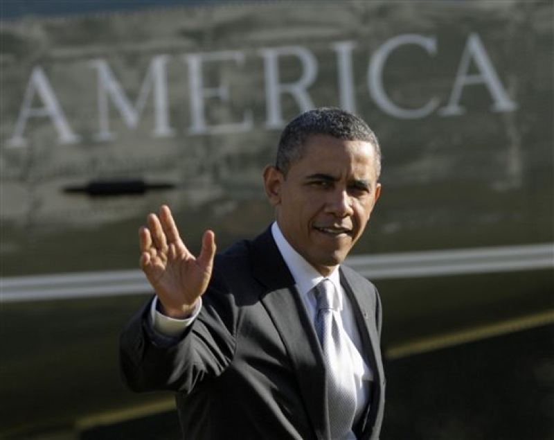 President Barack Obama waves as he walks off of Marine One on the South Lawn of the White House in Washington, Friday, Jan. 27, 2012. (AP Photo/Susan Walsh)