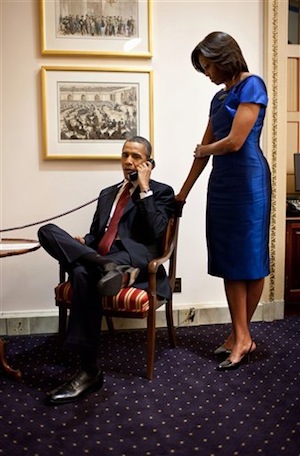 This photo provided by the White House shows President Barack Obama, accompanied by first lady Michelle Obama, during a phone call from the Capitol in Washington, Tuesday, Jan. 24, 2012, immediately after his State of the Union Address, informing John Buchanan that his daughter Jessica was rescued by U.S. Special Operations Forces in Somalia. (AP Photo/Pete Souza)