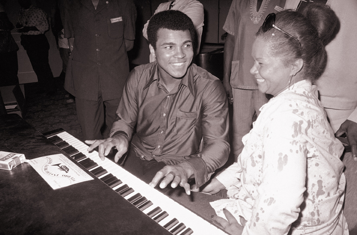 In this Sept. 22, 1974, photo, Muhammad Ali plays a few notes on the piano as singer Etta James looks on.