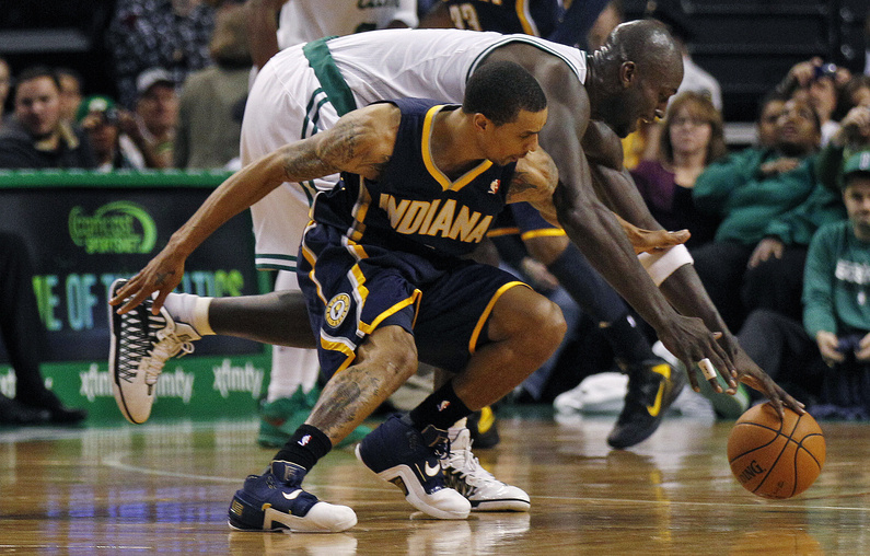 Celtics forward Kevin Garnett scrambles for a loose ball against Pacers guard George Hill during the second quarter Friday night in Boston. Boston won, 94-87.