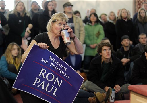 Kathleen Lawson sips coffee while listening to Ron Paul in Bangor.