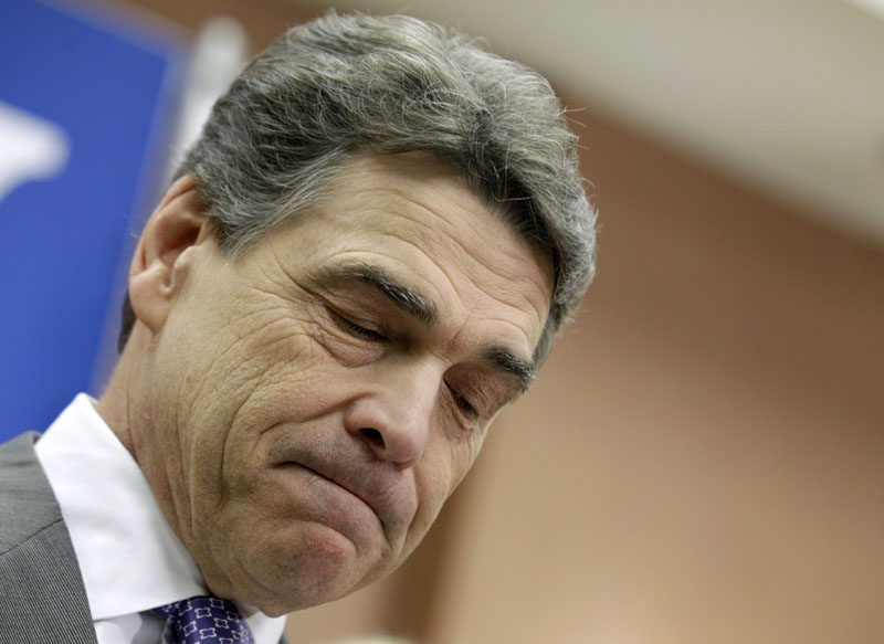 EXIT: Texas Gov. Rick Perry pauses Thursday while announcing in North Charleston, S.C., he was suspending his Republican presidential candidate campaign and endorsing Newt Gingrich.