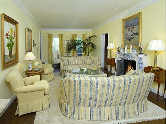 The living room in the home features a soft yellow color palette.