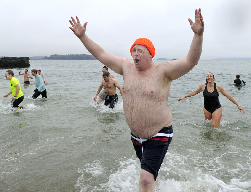 REFRESHING?: David Greenham, of Readfield, reacts after his plunge in the annual Polar Bear Plunge Saturday at the East End Beach in Portland.