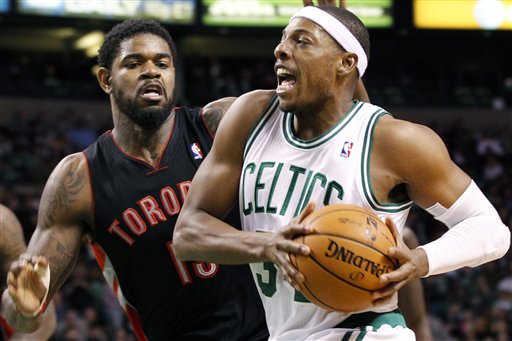 Boston Celtics forward Paul Pierce (34) drives past Toronto Raptors forward Amir Johnson (15) in the second quarter Wednesday in Boston.