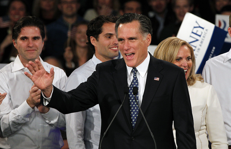 Former Massachusetts Gov. Mitt Romney, who won the New Hampshire tonight, waves to supporters at the Romney for President rally at Southern New Hampshire University in Manchester, N.H. Behind Romney are his sons Tagg and Craig and his wife Ann.