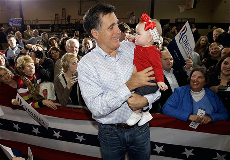 Republican presidential candidate, former Massachusetts Gov. Mitt Romney, carries 7-month-old Leah Locklear as he campaigns in Irmo, S.C. on Wednesday. (AP Photo/Charles Dharapak)