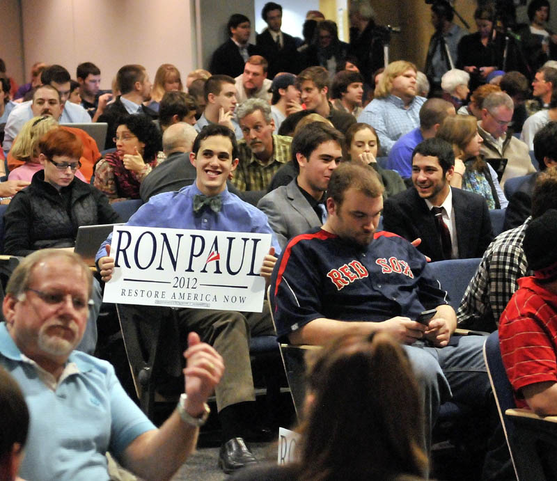 Staff photo by Michael G. Seamans Colby College junior, Brian Russo, center, displays his support for Republican Party presidential hopeful, Ron Paul at the Ostrove Auditorium at Colby College before Ron Paul speaks on Friday.