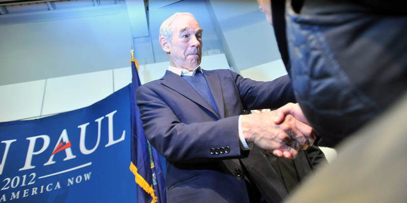 Staff photo by Michael G. Seamans Republican Party presidential hopeful, Ron Paul, shakes hands with supporters after a campaign speech at the Ostrove Auditorium at Colby College on Friday.