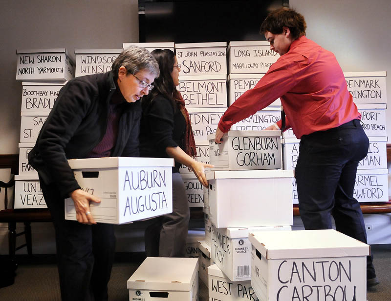 Volunteers stack boxes of signatures to put a same-sex marriage referendum on the ballot on Thursday in Augusta.