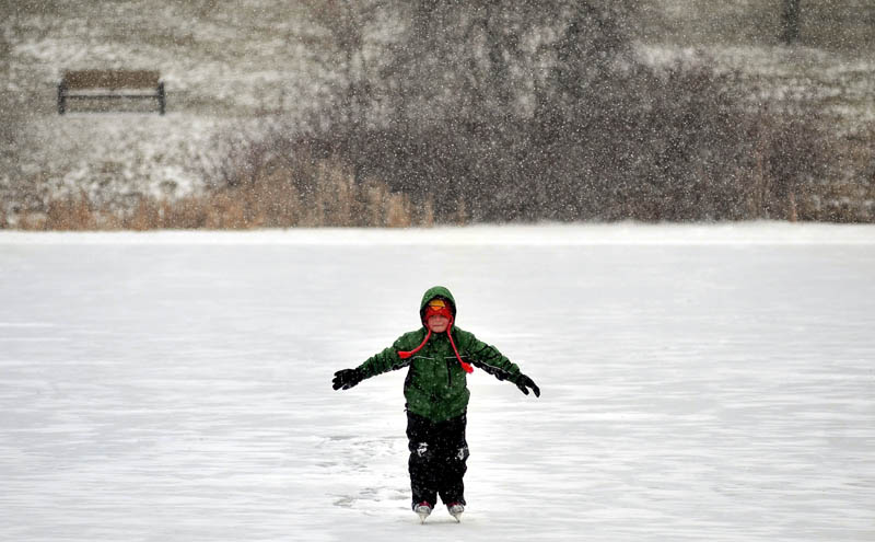 Tyler Margintan, 6, carefully skates across Johnson Pond at Colby College in Waterville as snow begins to fall on Thursday.