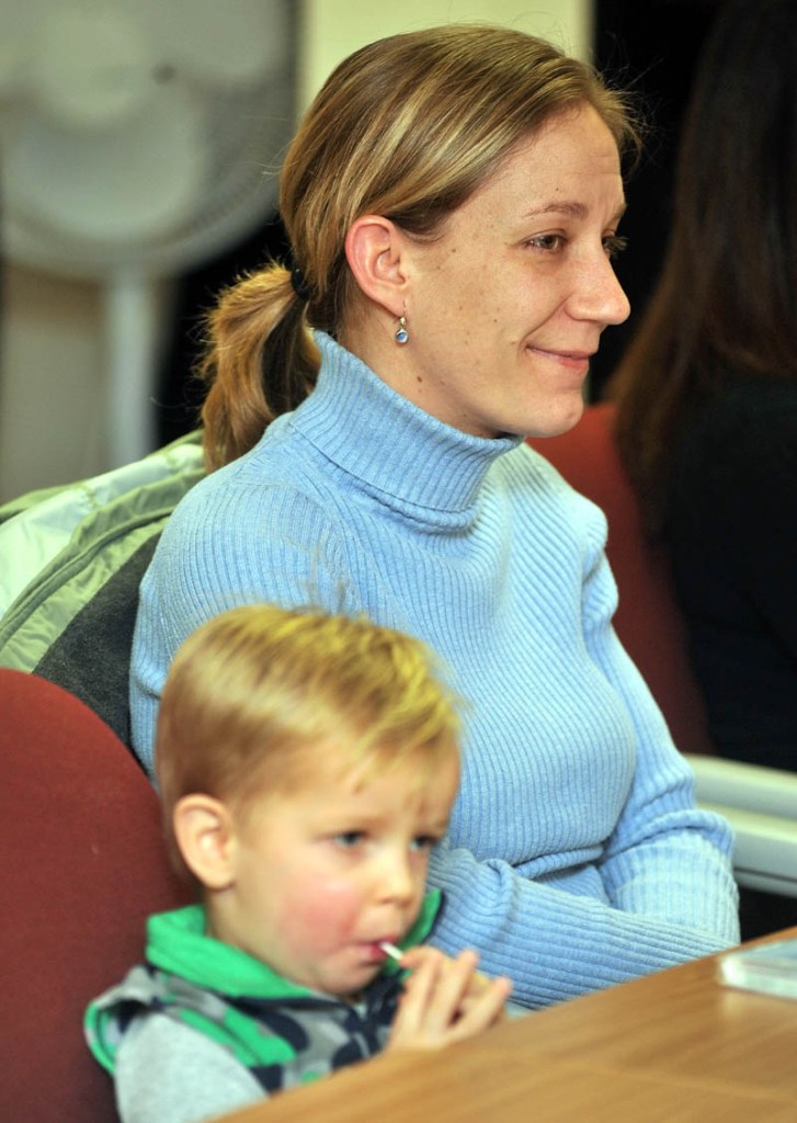 Lori Williams and her son Ethan Thomas Williams, 2, listen to Sen. Olympia Snowe during a discussion about heating assistance for low-income families at Kennebec Valley Community Action Program offices in Waterville on Thursday.