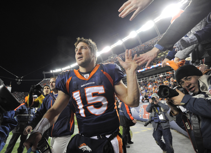 Denver Broncos quarterback Tim Tebow celebrates with fans after the Broncos defeated the Pittsburgh Steelers 29-23 in overtime of an NFL wild card playoff football game Sunday in Denver.