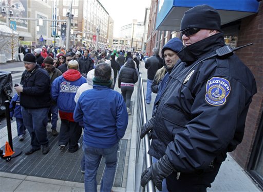 Officer David Bryant, right, of the Indianapolis Metropolitan Police, watches the crowd at the Super Bowl Village on Sunday. From pickpockets and prostitutes to dirty bombs and exploding manhole covers, authorities are bracing for whatever threat Super Bowl XLVI might bring.