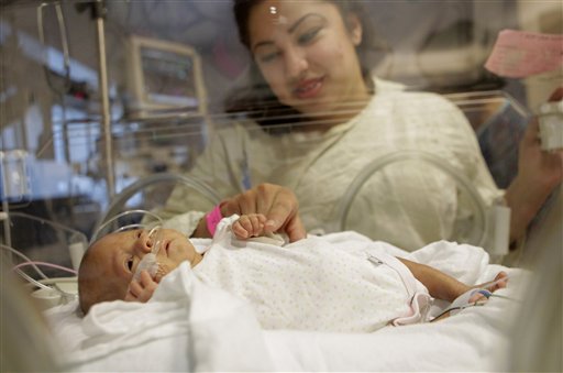 Haydee Ibarra looks at her 14-week-old daughter, Melinda Star Guido, at the Los Angeles County-USC Medical Center in Los Angeles. She is the world's third smallest baby and the second smallest in the U.S.
