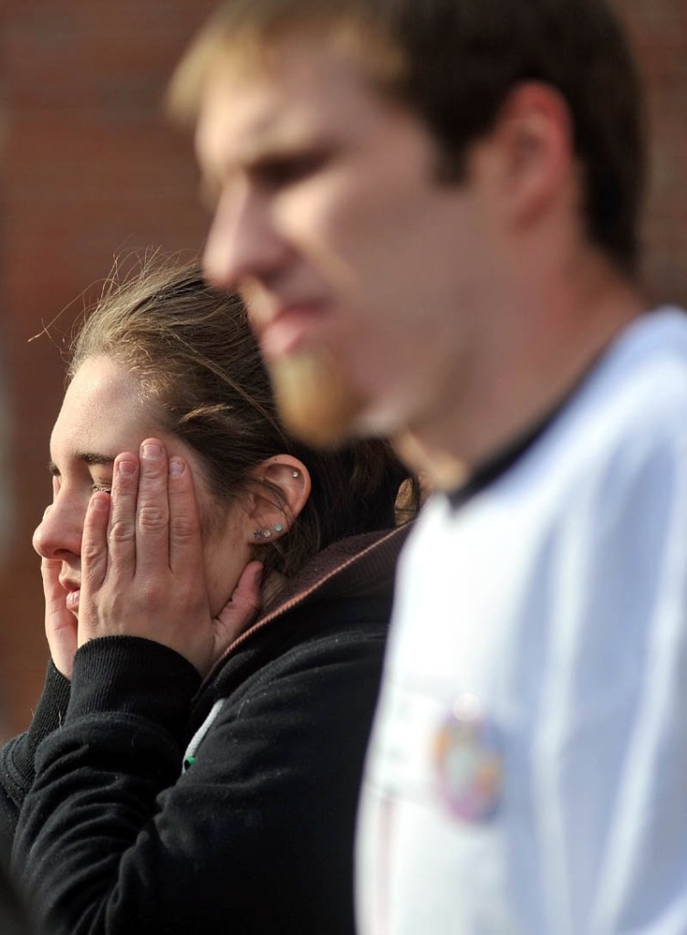 Staff photo by Michael G. Seamans Trista Reynolds, back, and Justin DePietro, speak to media during a vigil in Castonguay Square in Waterville for their missing toddler, Ayla Reynolds Saturday.