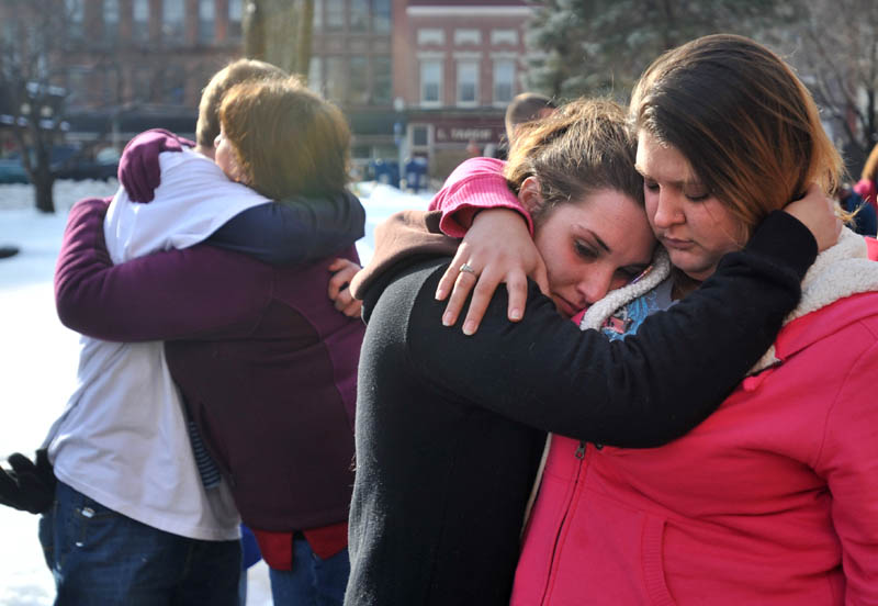 Staff photo by Michael G. Seamans Trista Reynolds, center, mother of Ayla Reynolds, is comforted by her friend Amanda Benner, during a vigil in Castonguay Square in Waterville for missing toddler, Ayla Reynolds Saturday.