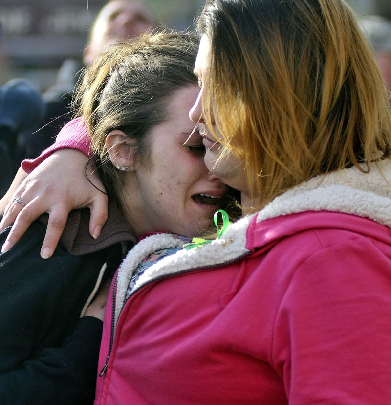 Staff photo by Michael G. Seamans Trista Reynolds, left, mother of Ayla Reynolds, is comforted by her friend Amanda Benner, during a vigil in Castonguay Square in Waterville for missing toddler, Ayla Reynolds Saturday.