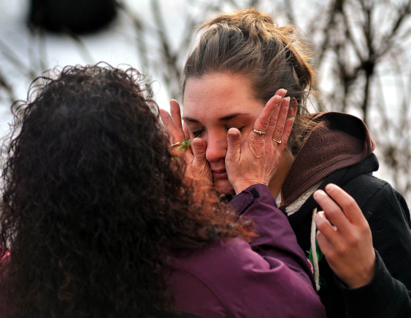 Staff photo by Michael G. Seamans Trista Reynolds, facing, has tears wiped away by a friend during a vigil in Castonguay Square in Waterville for her missing toddler, Ayla Reynolds Saturday.
