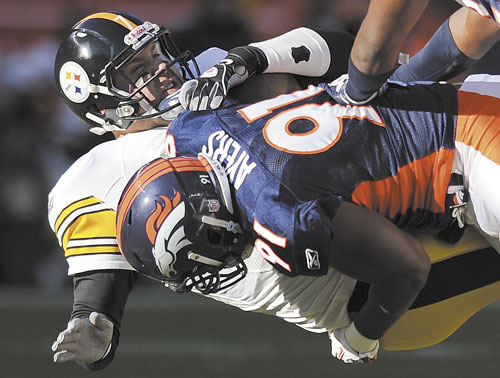 DOWN YOU GO: Denver Broncos defensive end Robert Ayers (91) hits Pittsburgh Steelers quarterback Ben Roethlisberger (7) after a pass in the first quarter of a wild card game Sunday in Denver.