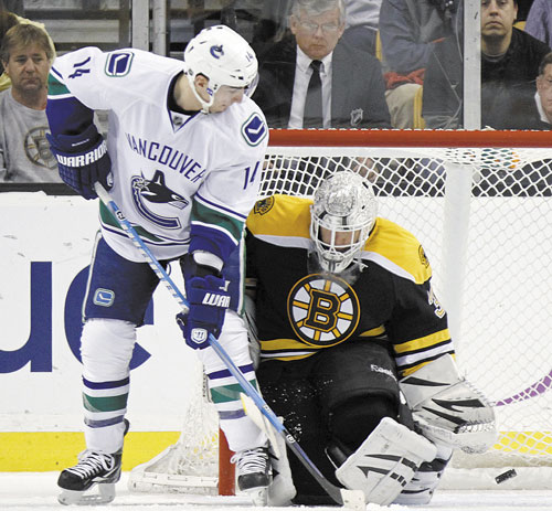 TOO LATE: Vancouver’s Alex Burrows (14) watches as the puck goes into the net past Boston goalie Tim Thomas in the second period Saturday in Boston.