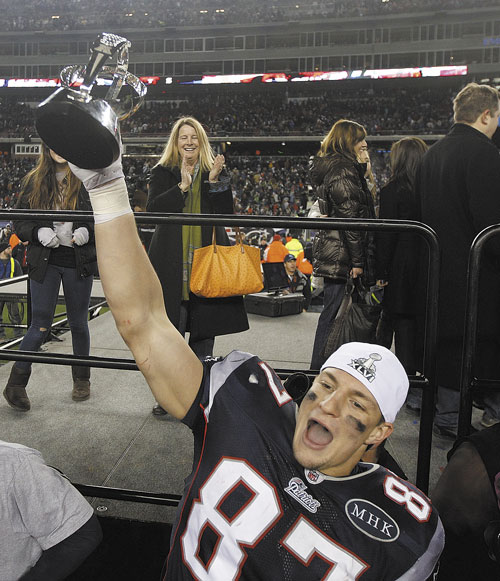 CONFERENCE CHAMPS: New England Patriots tight end Rob Gronkowski celebrates with the AFC Championship trophy last week in Foxborough, Mass. The Patriots defeated the Ravens 23-20 to win the AFC Championship.