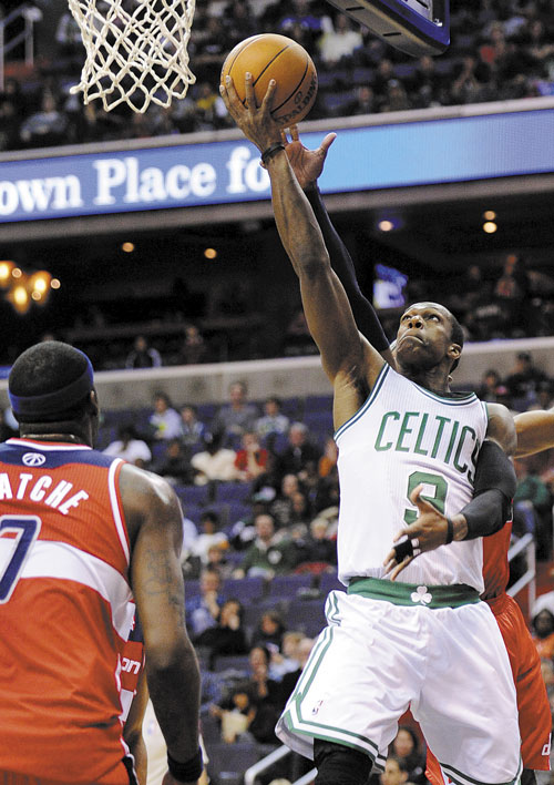 TO THE HOLE: Boston Celtics guard Rajon Rondo, right, goes to the basket against Washington Wizards forward Andray Blatche during the first half Sunday in Washington.