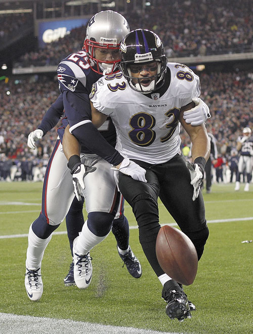 BIG PLAY: Baltimore Ravens wide receiver Lee Evans (83) is stripped of the ball by New England Patriots free safety Sterling Moore (29) during the second half of the AFC Championship game Sunday in Foxborough, Mass. The Patriots defeated the Ravens 23-20.