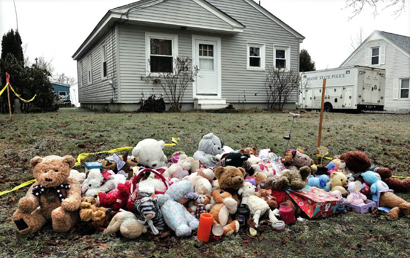 WAITING: A large pile of teddy bears and stuffed toys lies outside in the rain Saturday at 29 Violette Ave. in Waterville, near a state police crime laboratory truck parked in the driveway. The search for 20-month-old Ayla Reynolds became a criminal investigation last week.