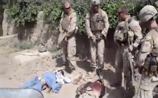 This image is from an undated video posted on the Internet on Wednesday, Jan. 11, 2012 by a YouTube user, which purports to show four U.S. Marines urinating on the corpses of Taliban fighters. (AP Photo)
