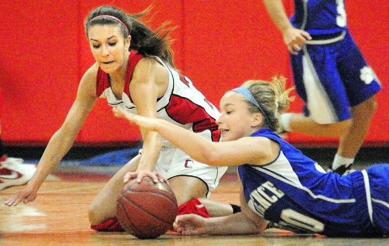 Cony's Josie Lee, left, and Lawrence's Brianna Soucy battle for the ball on the floor during a game Tuesday night at Cony High in Augusta. The Rams won 62-36. For local roundups, see C3.