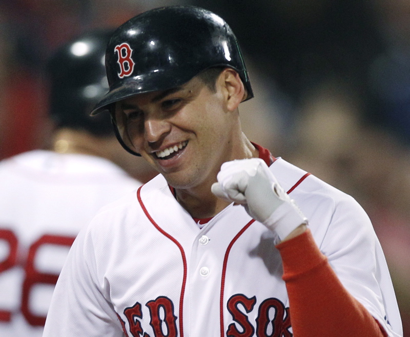 Jacoby Ellsbury pumps his fist after scoring on an inside-the-park home run against the Orioles at Fenway Park in September 2011.