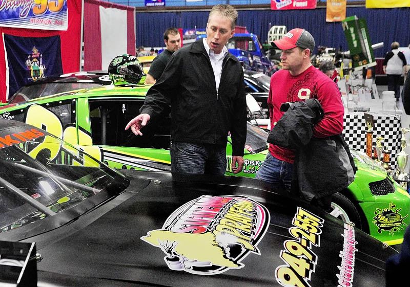 IT’S RIGHT THERE: Andy Santerre, left, and Nick Jenkins chat about the late model class car that Jenkins will race at Speedway 95 this season during the opening night of the Northeast Motorsports Expo on Friday evening at the Augusta Civic Center.