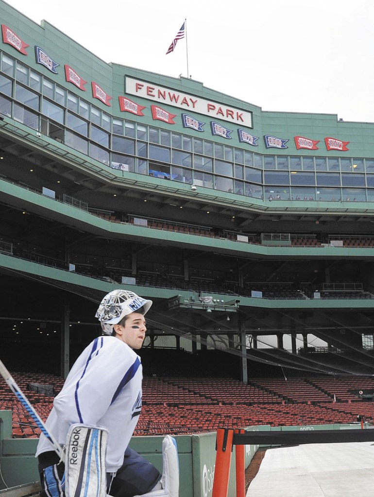 PLAY HOCKEY: Martin Ouelette of the University of Maine hockey team steps out of the Red Sox dugout and into Fenway Park on Friday, January 6 to practice for Saturday’s Frozen Fenway game vs. UNH.
