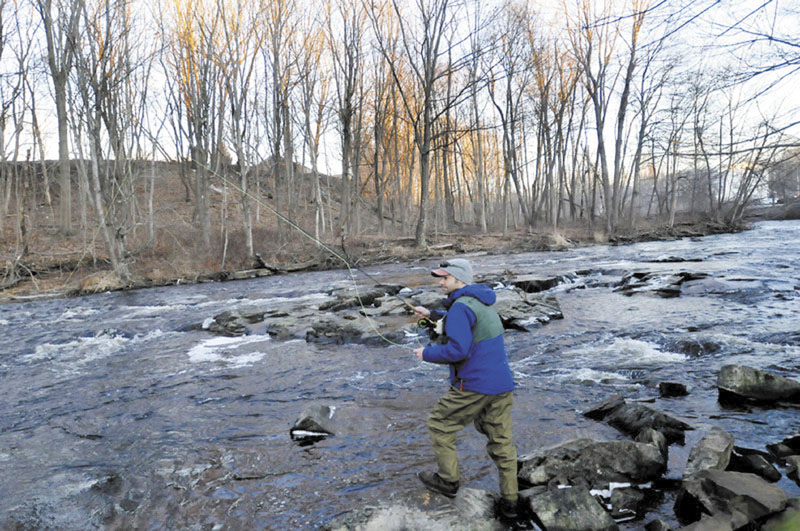 NICE DAY TO WET A LINE: Aaron Landry of Standish was one of approximately 70 fly fishermen who participated in this year’s Freeze Up gathering.