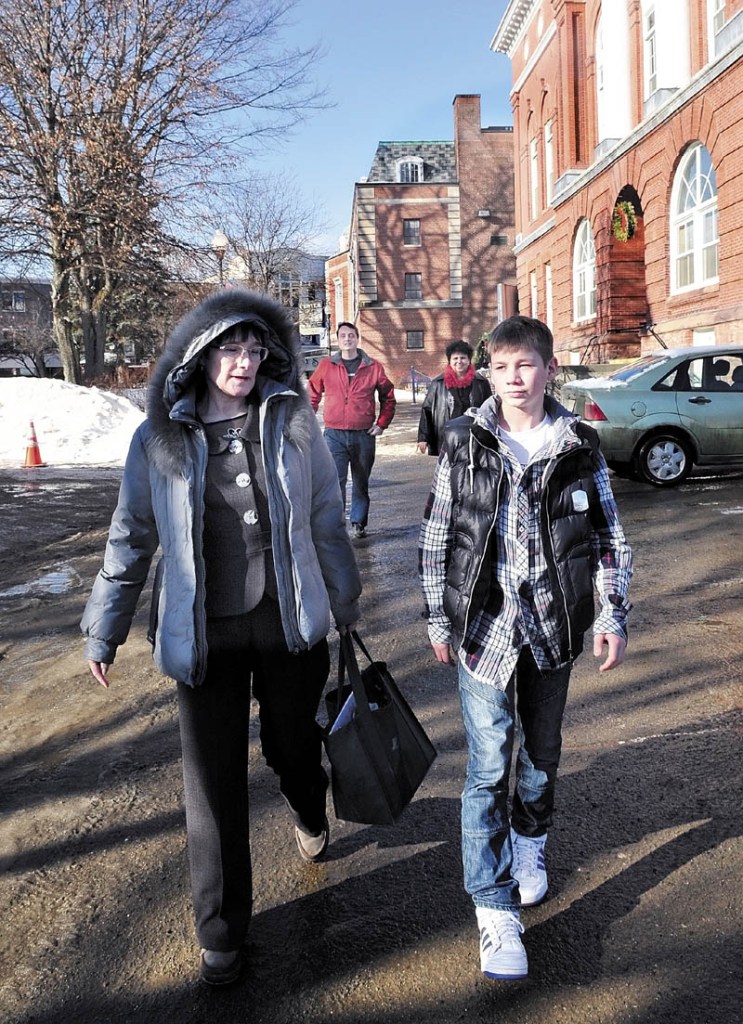 TOUR: Arina Pavlova and Anton Yeltsov of Kotlas, Russia, walk in Waterville after touring city hall followed by area hosts Mark Fisher and Martha Patterson. Waterville and Kotlas are sister cities.