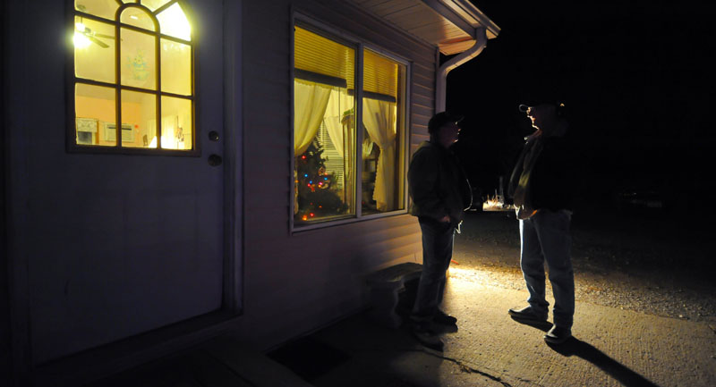 UP FOR GRABS: Chris Kreger and John Carr talk outside a caucus Tuesday night at Precinct 42 near Smithland, Iowa. This caucus race was jumbled as any in the 40 years since Iowa gained the presidential campaign lead-off position.