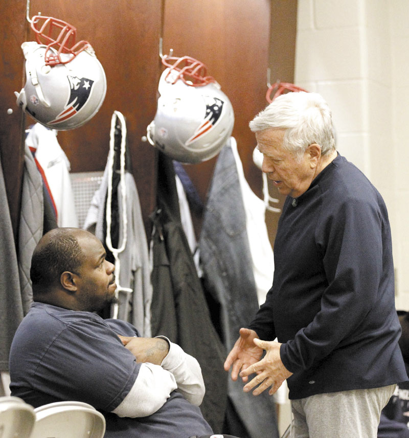 HEY BUDDY: New England Patriots owner Robert Kraft, right, talks with nose tackle Vince Wilfork in the Patriots locker room earlier this week. Kraft, whose wife Myra died earlier this year, said the team is an extended family for him.