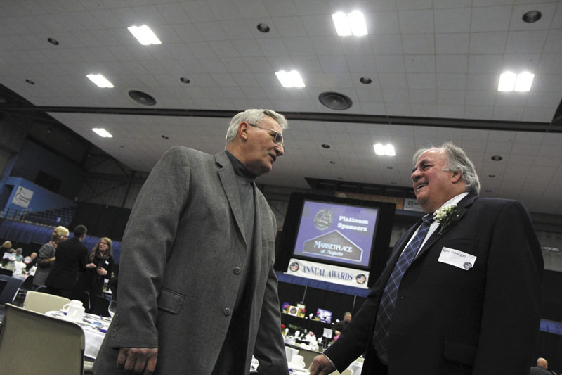 John Finnegan, president of Macomber, Farr & Whitten, right, chats with lifelong friend Richard Boucher of Augusta prior to receiving the Business Person of the Year award at the Kennebec Valley Chamber of Commerce’s annual awards banquet at the Augusta Civic Center on Friday night.