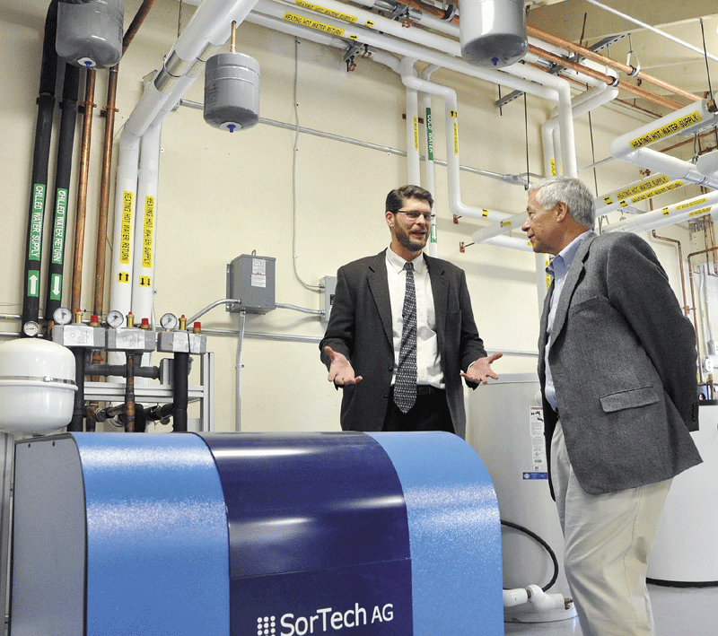 Dana Doran, director of energy programs at Kennebec Valley Community College, left, and U.S. Rep. Mike Michaud, D-2nd District, pause during a tour of the college’s Northeast Solar Heating and Cooling Instructor Training Project at the Fairfield campus on Friday.