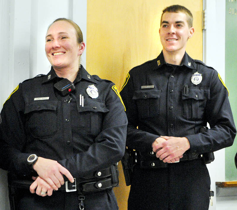 Augusta's newest police officers Carly Smith, left and Adam Moody smile during an event welcoming them to the department on Thursday afternoon.