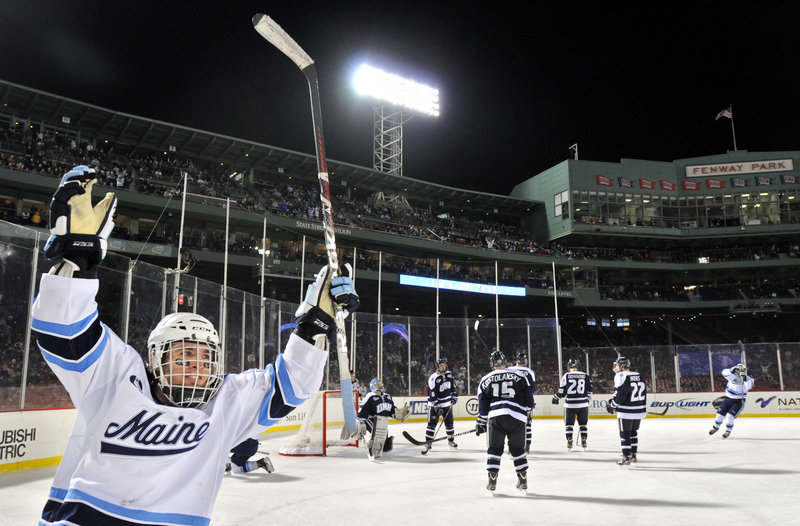 Joey Diamond celebrates teammate Brian Flynn’s overtime goal Saturday night that gave the University of Maine a 5-4 victory over Hockey East rival New Hampshire at Fenway Park.