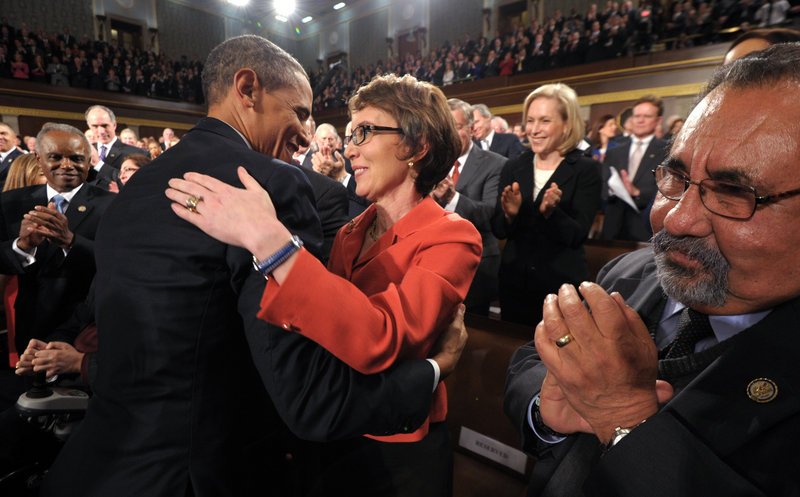 President Obama embraces retiring Rep. Gabrielle Giffords, D-Ariz., who survived an assassination attempt a year ago, as others applaud before his State of the Union address Tuesday night in front of a joint session of Congress in Washington.