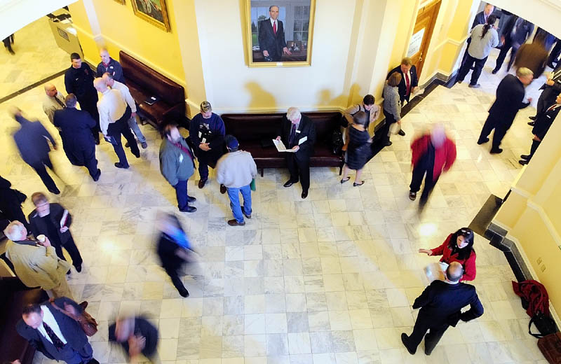 People move through the third floor between the House and Senate chambers on Wednesday at the State House in Augusta. It was the first day of the 125th Legislature’s second legislative session.