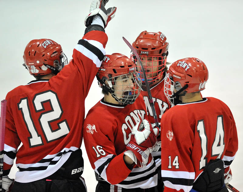 GOOD START: Cony High School’s Aaron Manter (16) celebrates his first-period goal with teammates Zach Gagne, left, Dakota Bowie, back center, and Austin Davis during the Rams’ 2-0 win over Skowhegan Area High School on Saturday at Sukee Arena in Winslow.