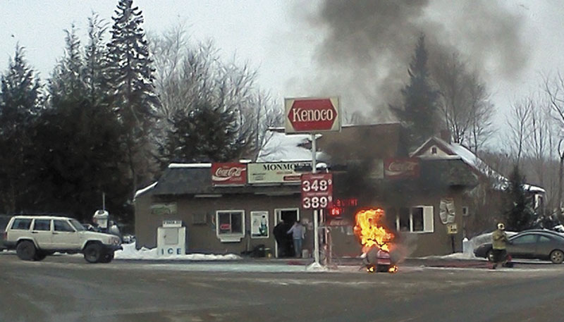 A snowmobile burns Sunday about 3:30 p.m. at the Monmouth Kwik Shop on Main Street in Monmouth.